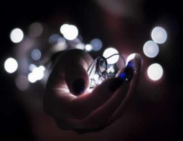 Main tenant une guirlande lumineuse